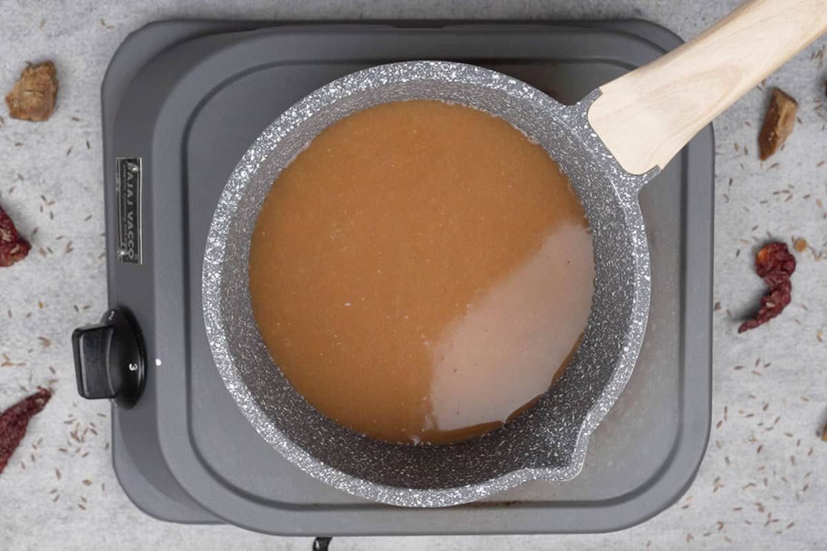 Tamarind water transferred to a pan.