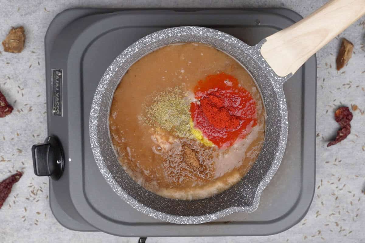 Spice powders added to the pan.