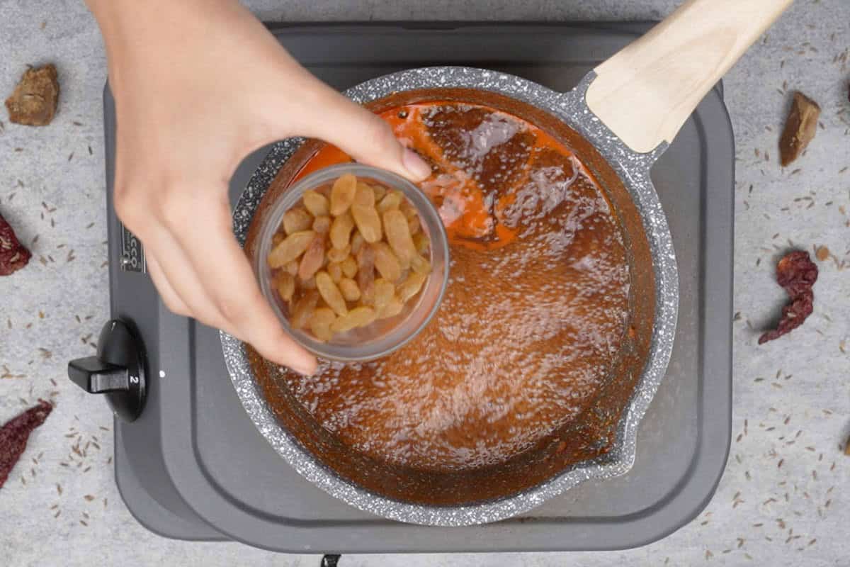 Adding raisins to the pan.