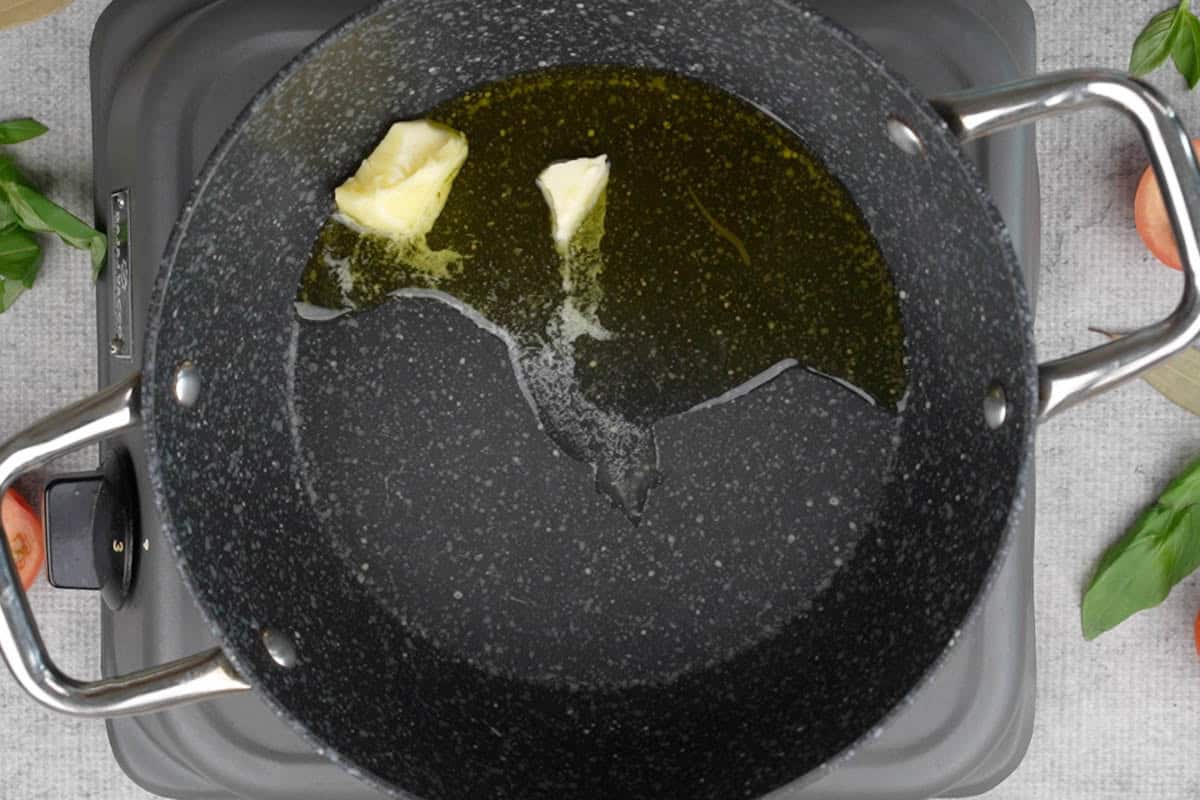 Oil and butter heating in a pan.