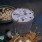 Blueberry boba tea served in a glass.