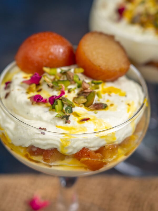 Rabdi Gulab Jamun Parfait is a lip-smacking fusion dessert prepared with layers of gulab jamun, rabdi-infused whipped cream, rose petals and nuts. Try my easy recipe here.