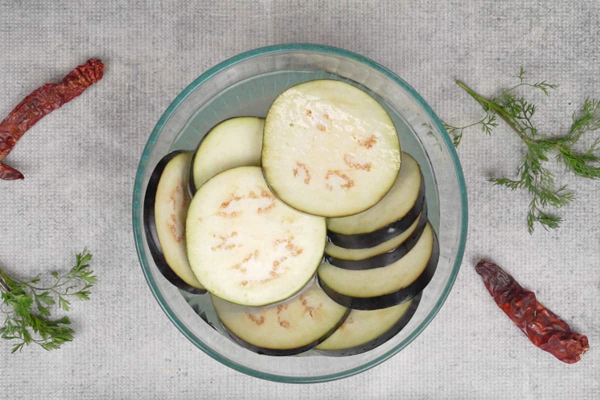 Soaked eggplant slices in salted water.