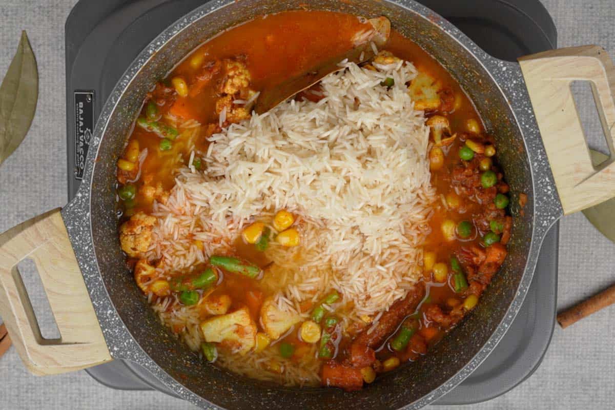 Soaked rice, water and lime juice  added to the pan.