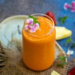 Sunrise sunset tropical smoothie served in a glass.