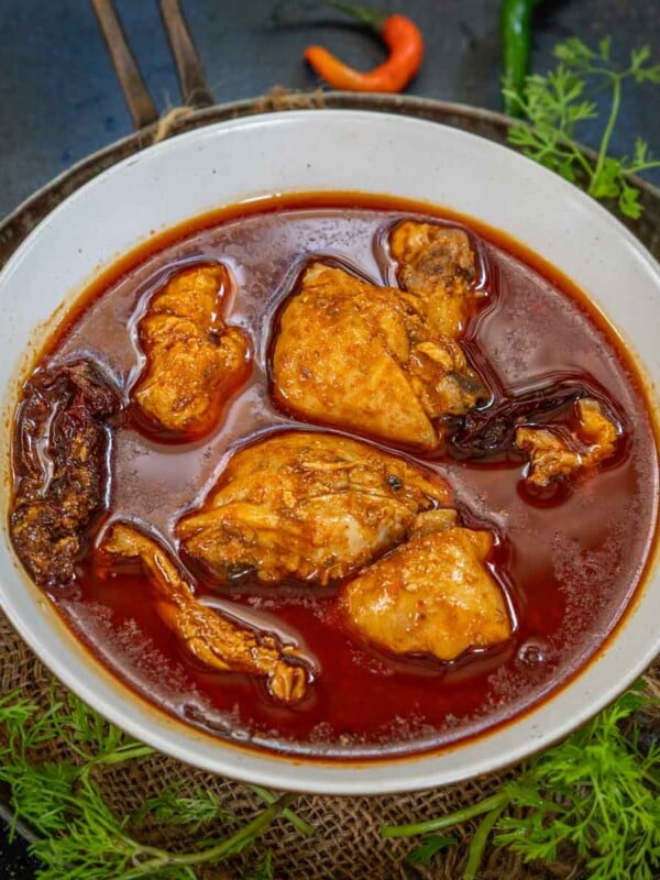 Chicken Rogan Josh is a traditional Kashmiri chicken curry where chicken pieces are cooked in a thin spicy curry flavored with fennel seeds and dried ginger powder. Make this authentic recipe at home using my easy instructions.
