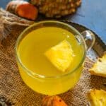 Pineapple ginger turmeric tea served in a cup.