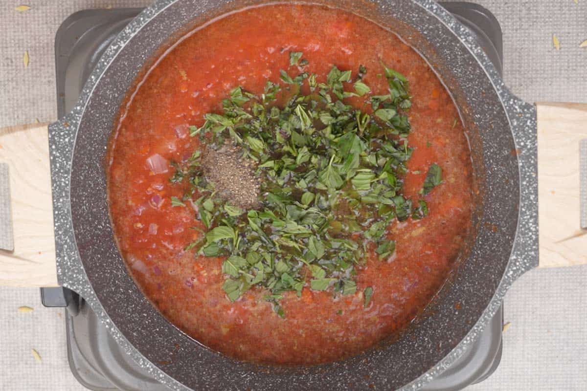 Broth, basil, salt and pepper added to the pan.