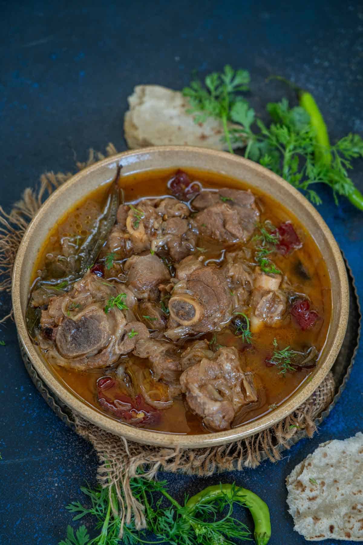 Mughlai mutton stew served in a bowl.