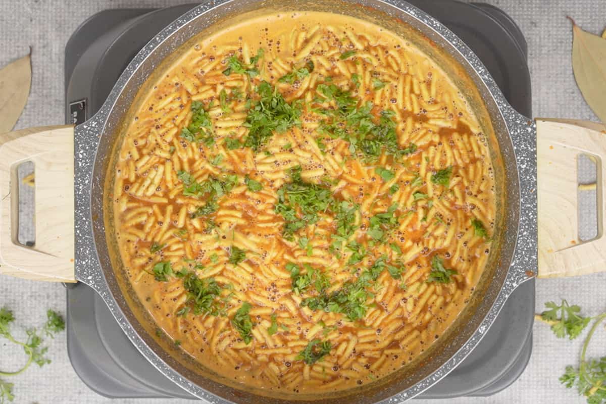 Lime juice and chopped cilantro added to ready shev bhaji.