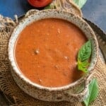 Tomato plum soup served in a bowl.