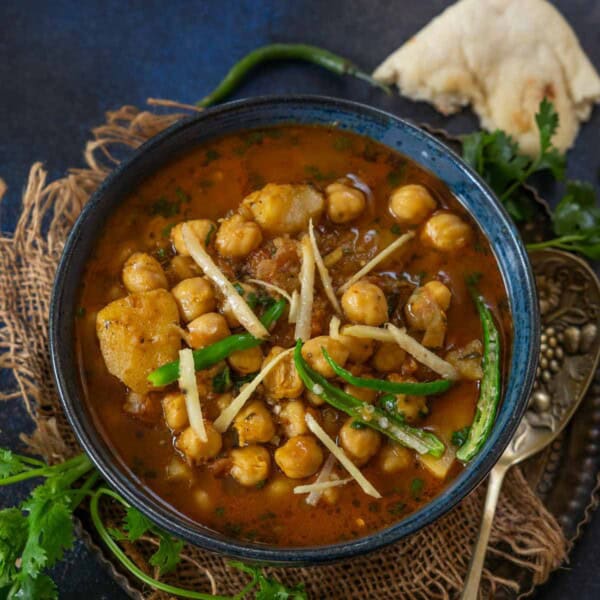 Aloo Chole is a North Indian-style curry made using chickpeas, potatoes, onions, tomatoes, and spices. Make it using my easy recipe.