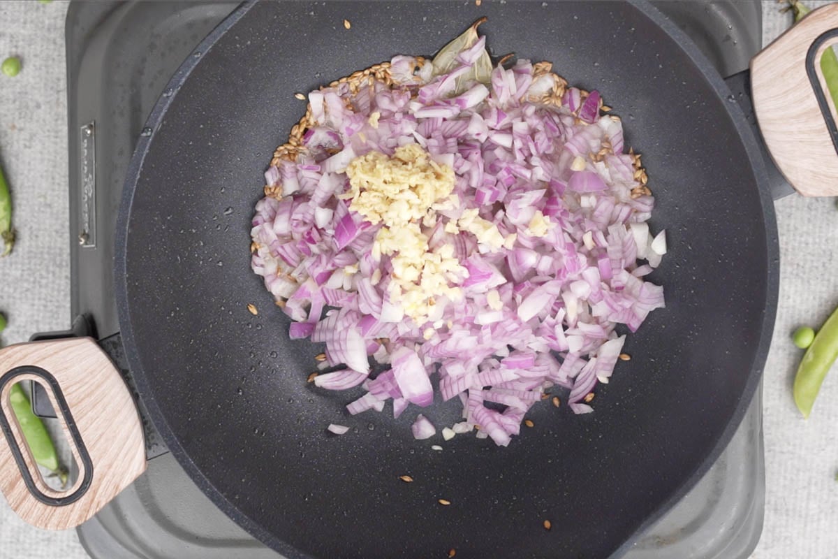 Onion, ginger and garlic added to the pan.