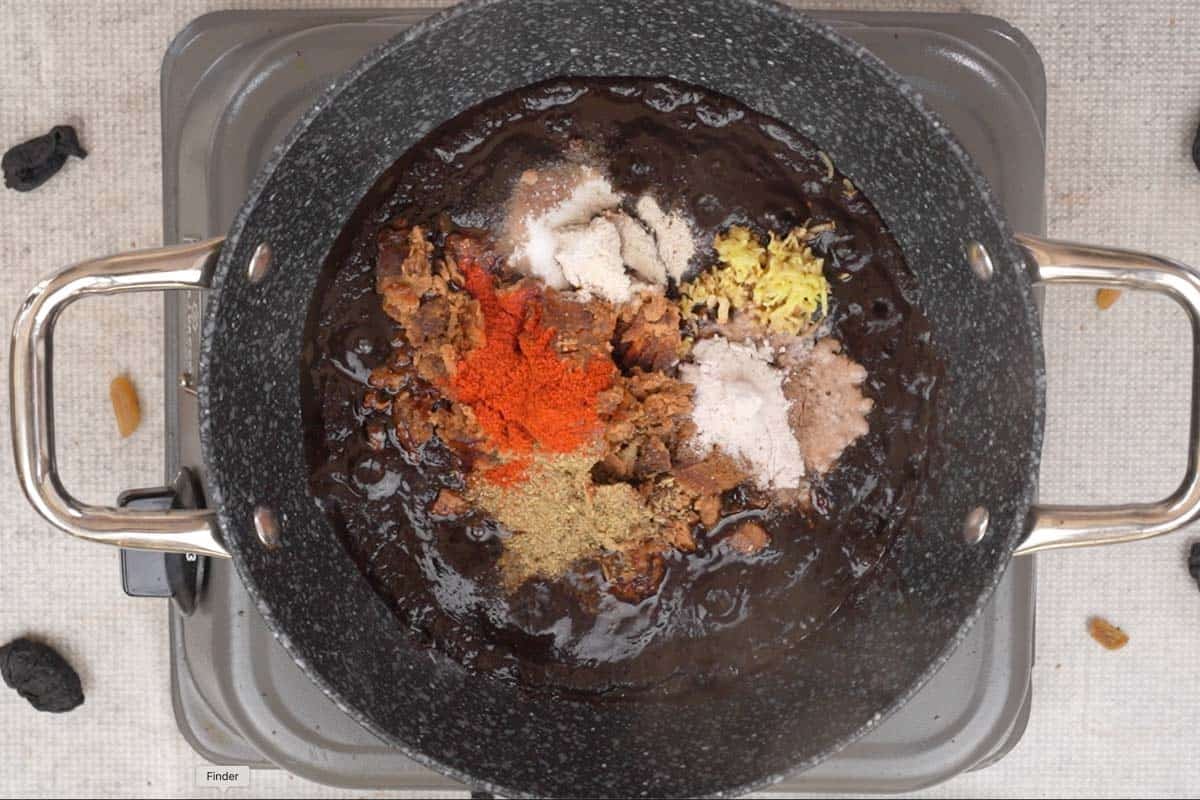 Kokum paste and spices added to a pan.