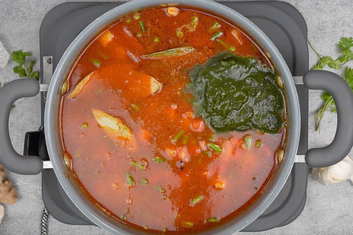 Green paste added to the pan.