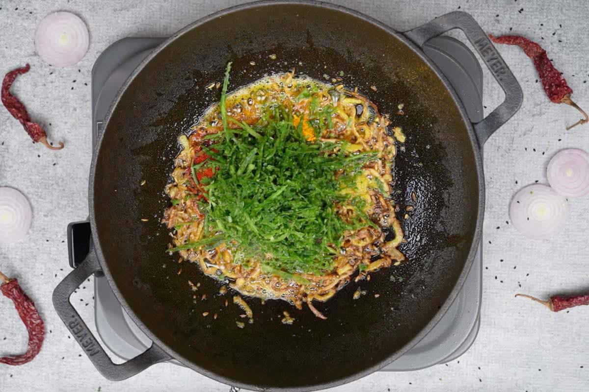 Spice powders, salt and karela peel added to the pan.