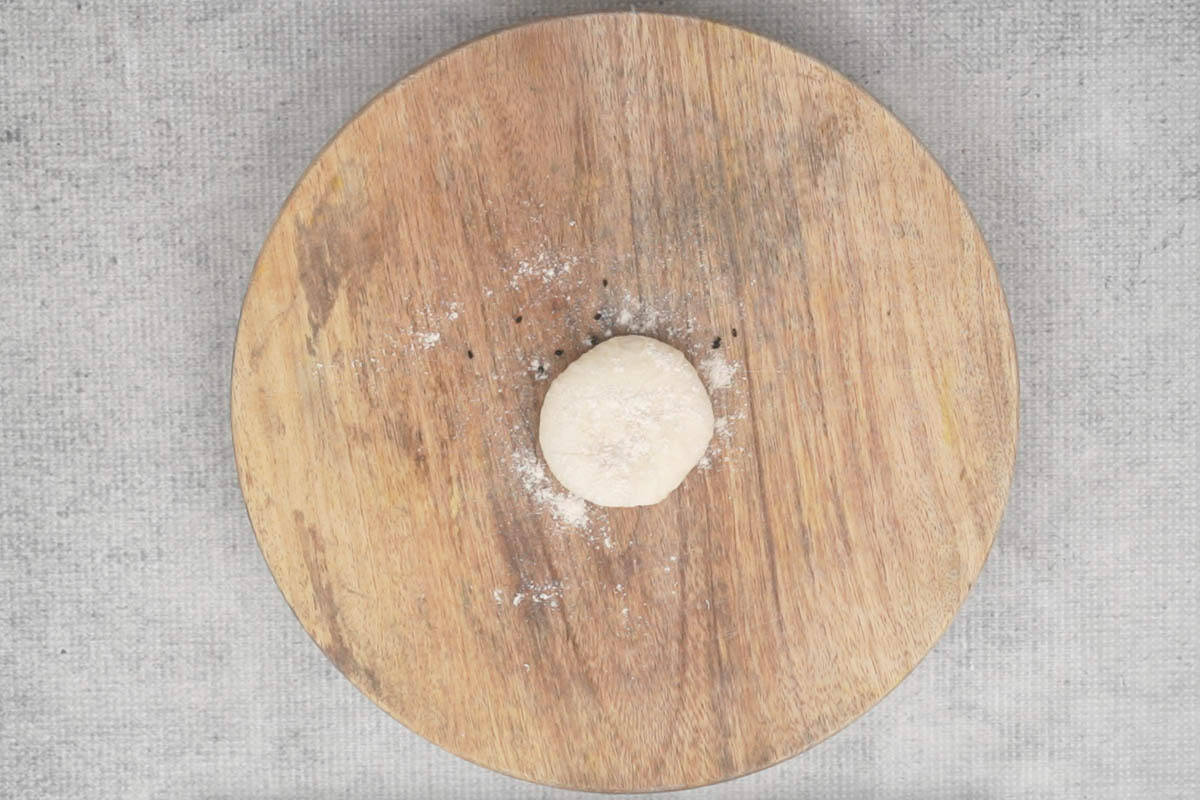 Dough ball kept over kalonji seeds.