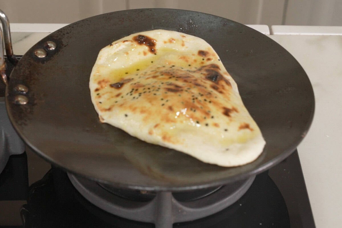 Ready butter naan on the tawa.