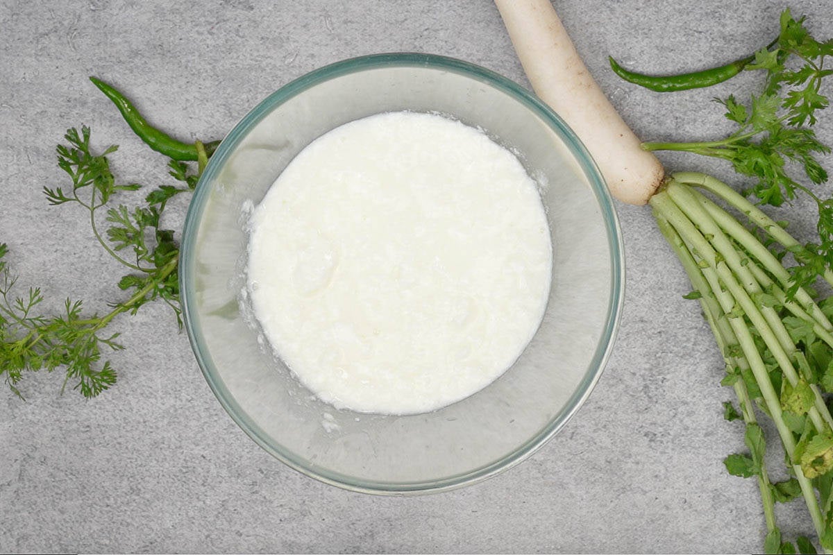 Yogurt whisked in a bowl.