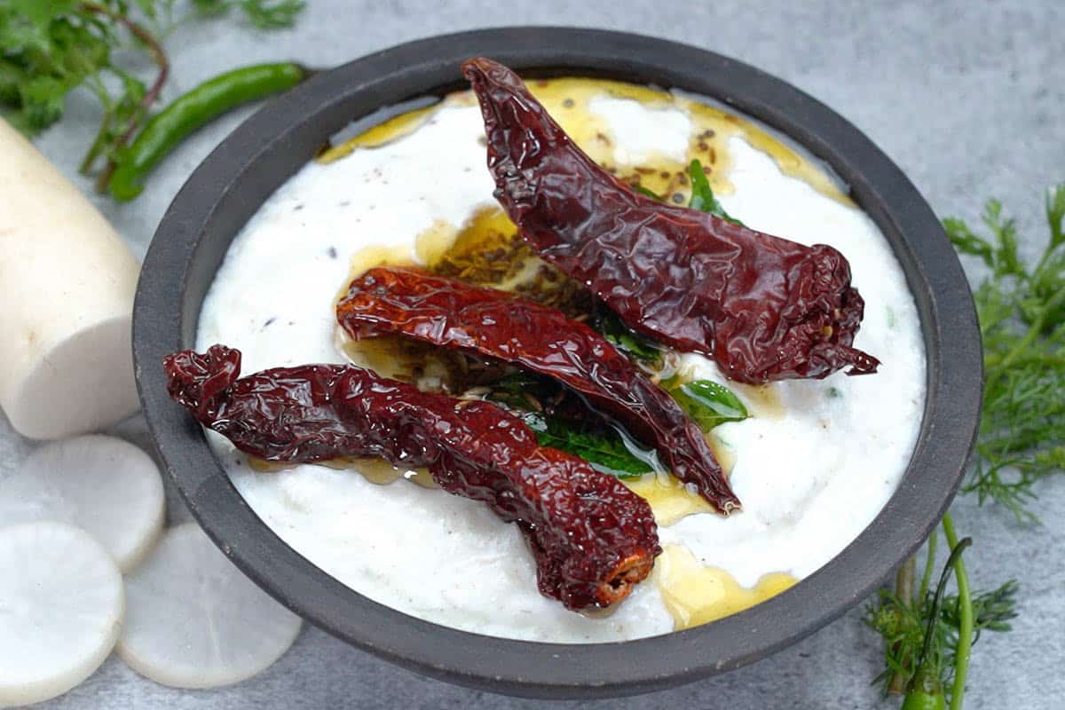 Tempering poured over ready mooli raita.