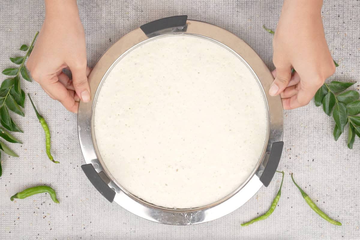 Rava dhokla batter poured in the prepared plate.