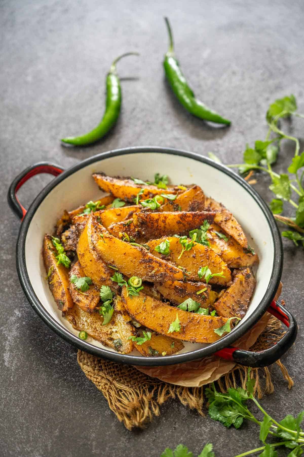Aloo anardana sabji served in a bowl.