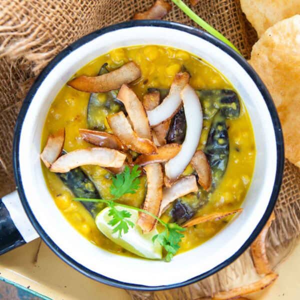 Cholar Dal is a traditional Bengali lentil dish prepared from chana dal (Bengal gram lentil), ghee, coconut, and a few spices. It is sweet and savory and is best paired with luchi or steamed rice. Make it using my easy recipe.