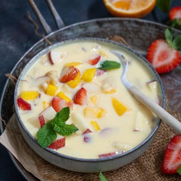 Fruit Custard is a delicious Indian dessert made with eggless custard powder and a variety of seasonal fruits. Make it using my easy recipe.