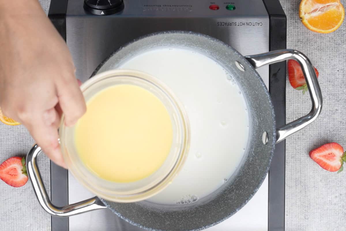 Adding custard mixture to the pan.