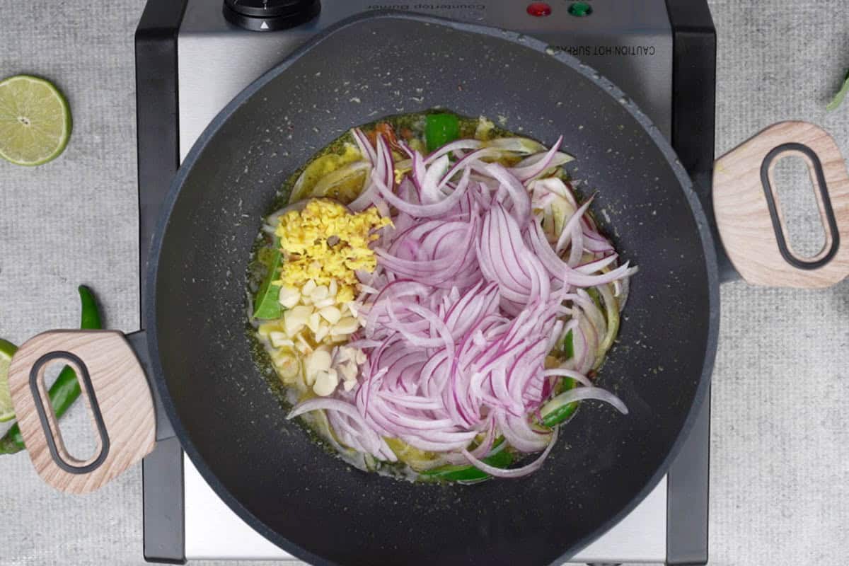 Onions, ginger and garlic added to the pan.