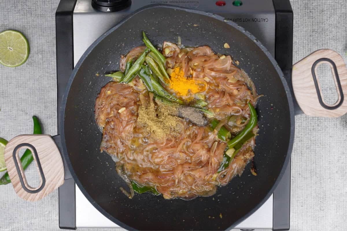 Coriander powder, turmeric powder and black pepper powder added to the pan.