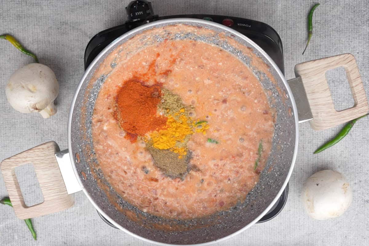 Spice powders added to the pan.