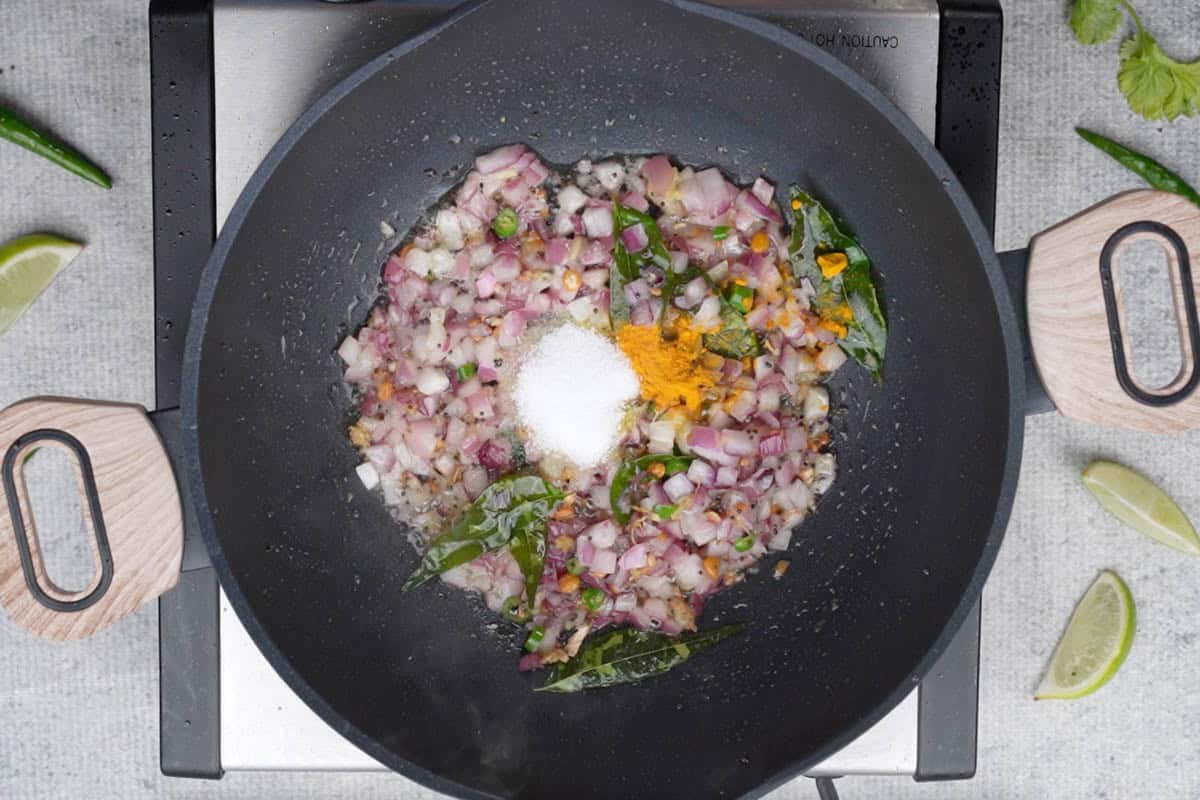 Turmeric and salt added to the pan.