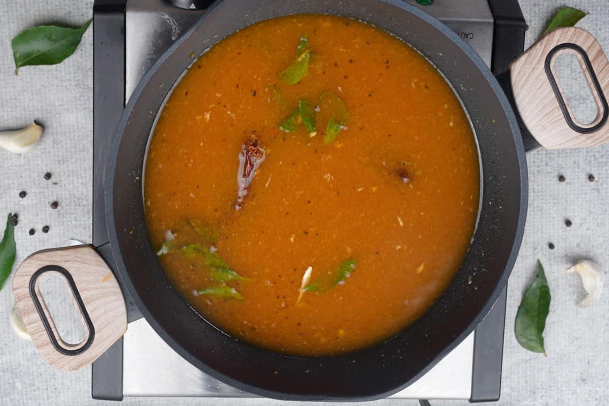 Water and tamarind paste added to the pan.