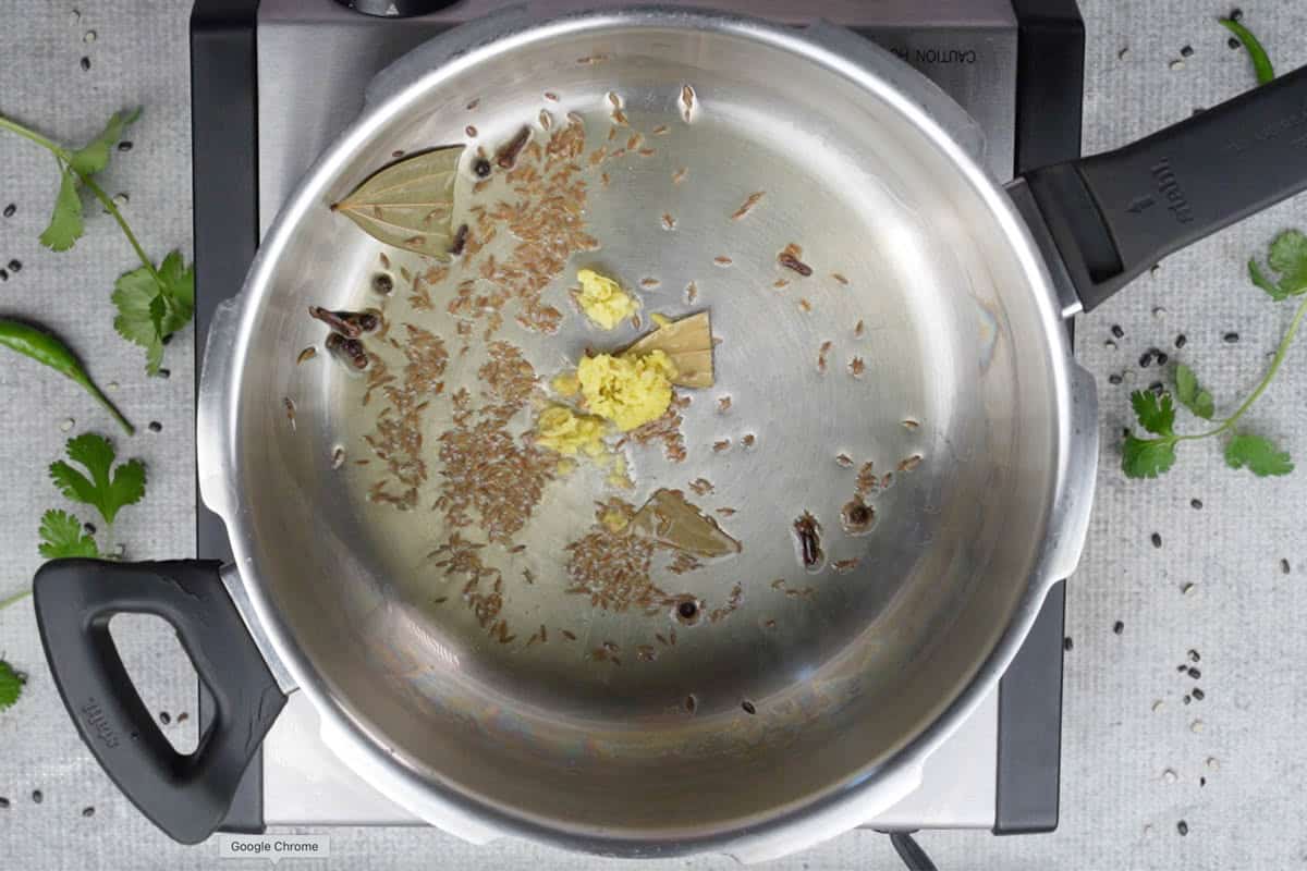 Grated ginger added to the cooker.