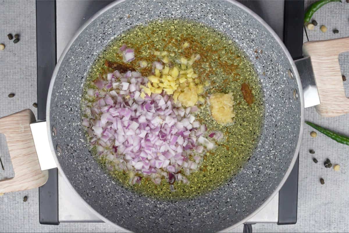 Ginger, garlic and onions added to the pan.
