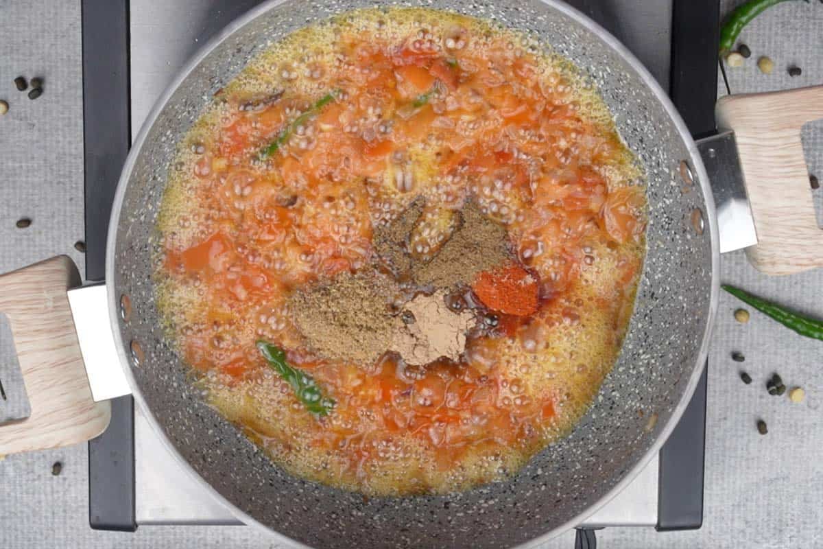 Spice powders added to the pan.