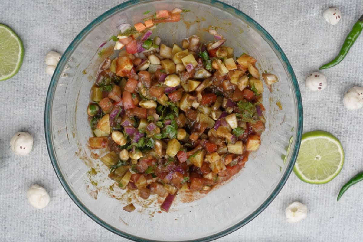 Chutneys, spices and lime juice mixed with the ingredients in the bowl.