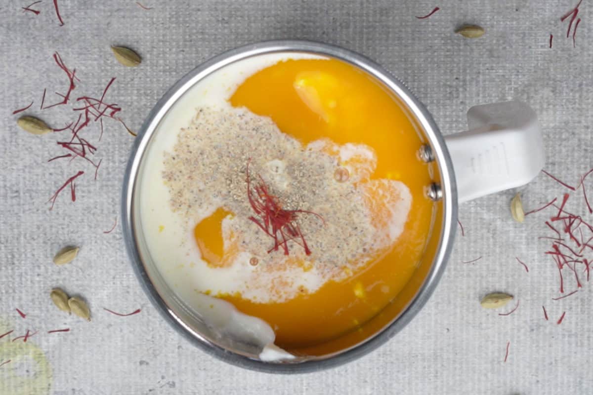 All the mango lassi ingredients added to a blender.