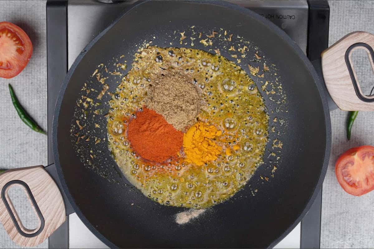 Coriander powder, chili powder and turmeric powder added to the pan.