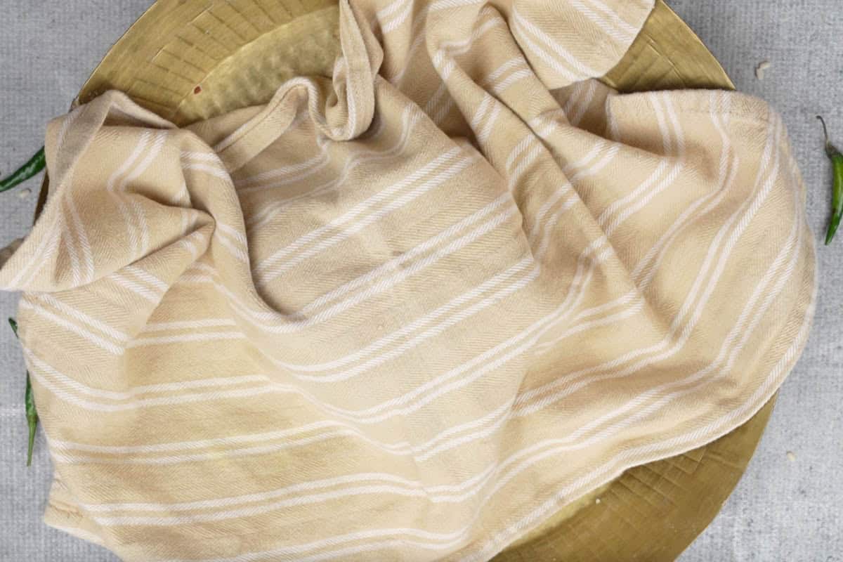 Dough covered with a damp cloth.