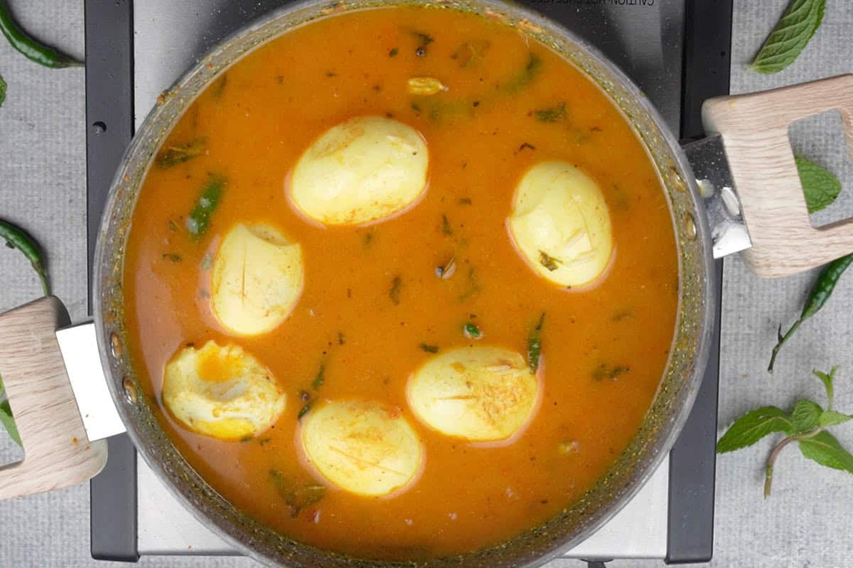 Water, lime juice and seared eggs added to the pan.