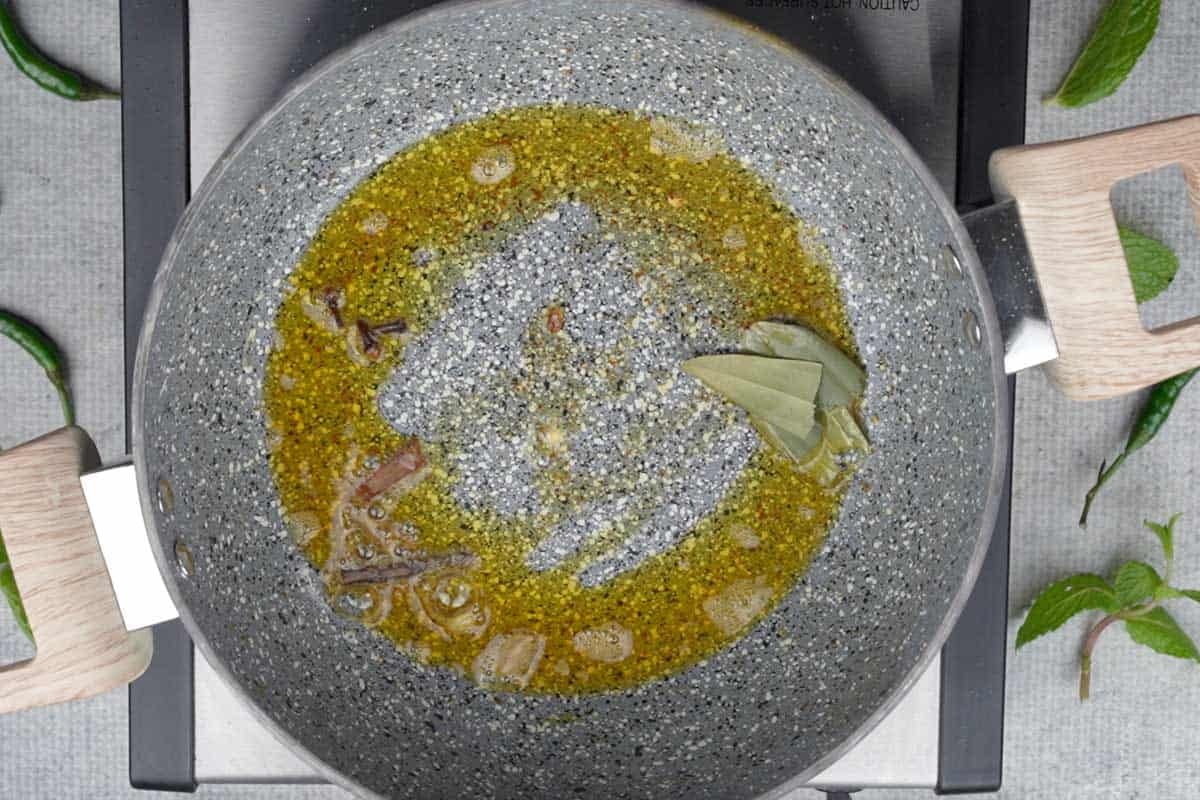 Whole spiced added to the pan.