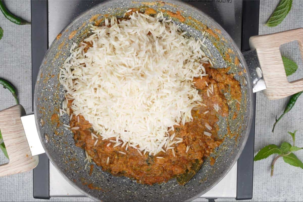 Soaked rice added to the pan.