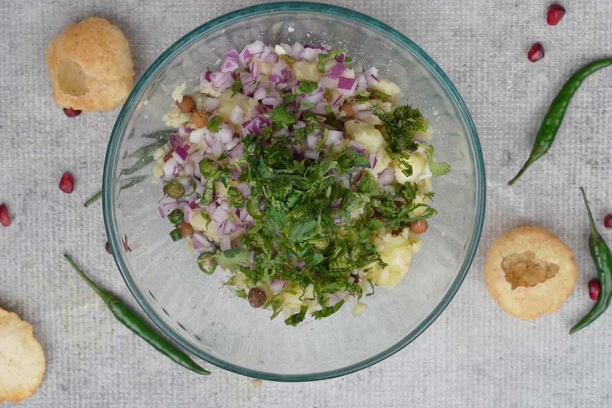 Onions, cilantro and green chilies added to the bowl.