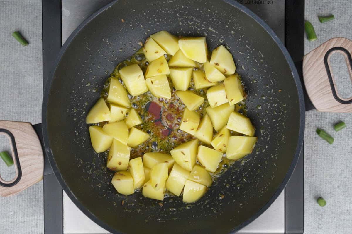Cubed potatoes added to the pan.