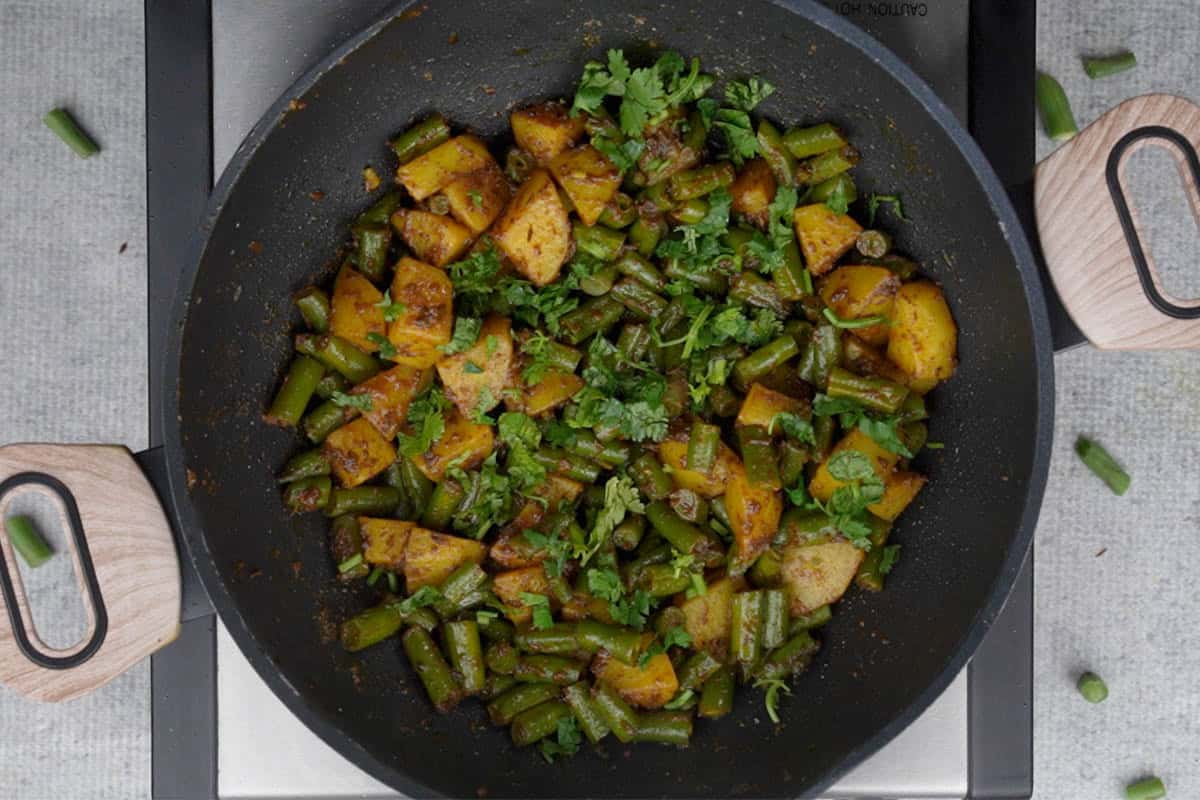Ready aloo beans garnished with chopped cilantro.
