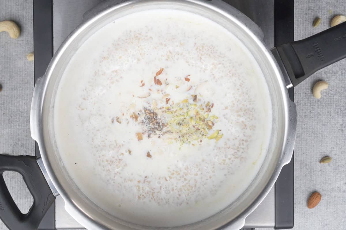 Sugar, cardamom and nuts added to the cooker.