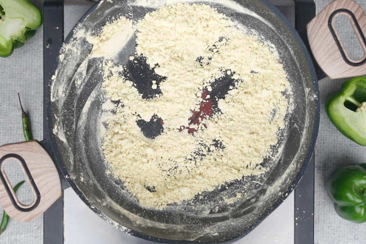 Roasted besan in a pan.