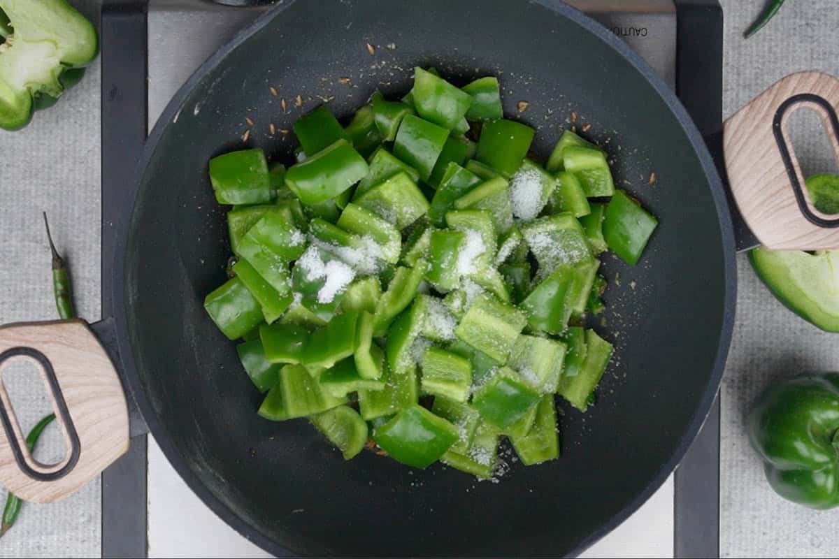 Capsicum and salt added to the pan.
